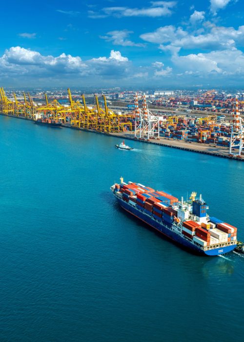 Aerial view of cargo ship and cargo container in harbor.