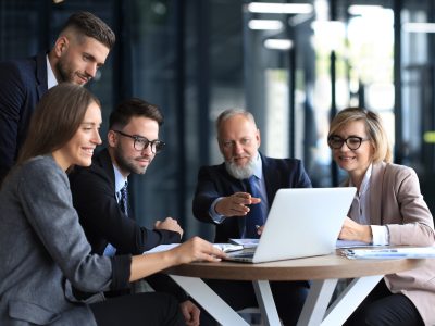 Business team working on laptop to check the results of their work