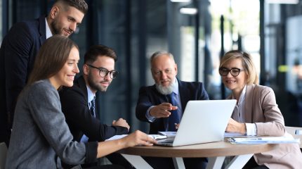 Business team working on laptop to check the results of their work