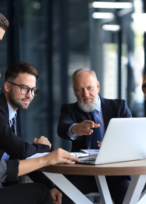 Business team working on laptop to check the results of their work